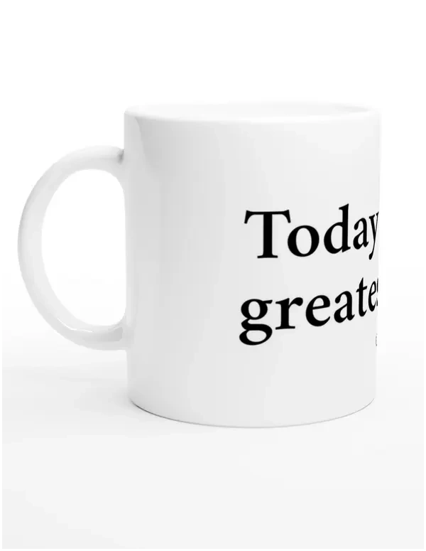 A white ceramic mug with a quote from Sól Déore, 'Today is the greatest gift', viewed from the left.